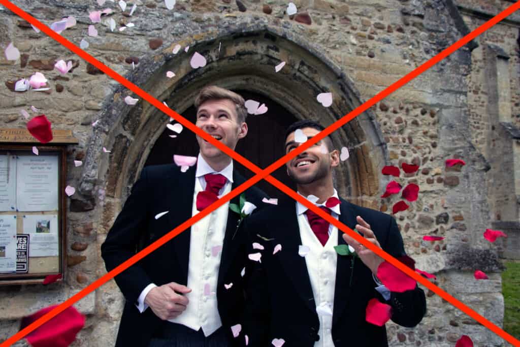 Gay weddings newly wed men, dressed in matching morning suits leave village church with smiles and are showered with coffetti.