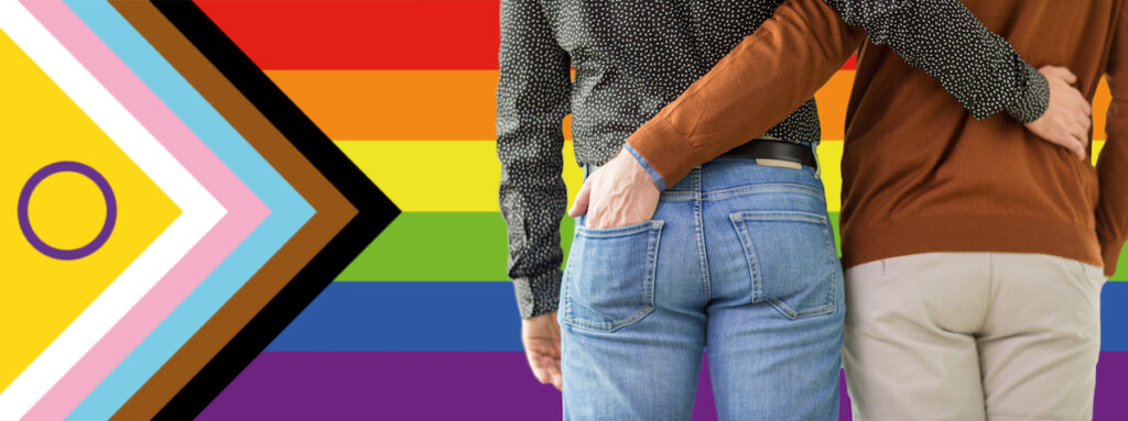 close up of male gay couple over pride flag