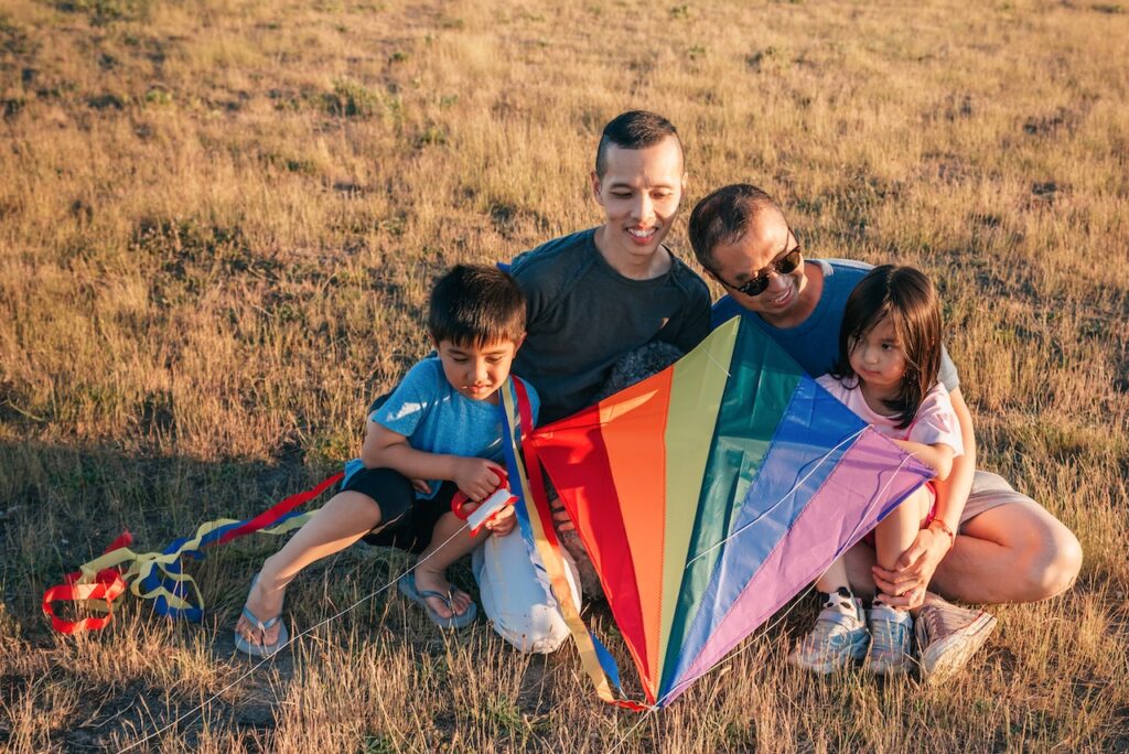 gay couple with 2 kids and rainbow kite