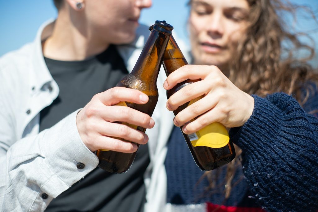 A Couple Doing a Toast with non alcoholic Beer Bottles